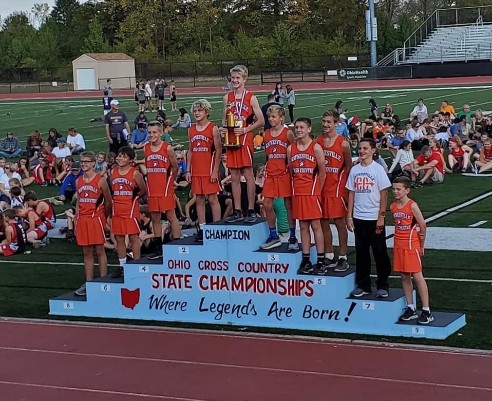 boys cross country team in orange uniforms